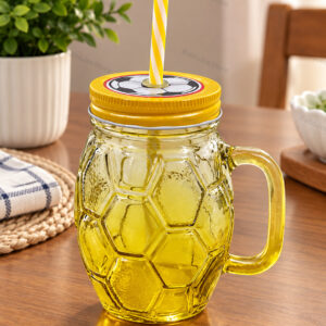 Clear handled football-style glass drink jar with striped straw