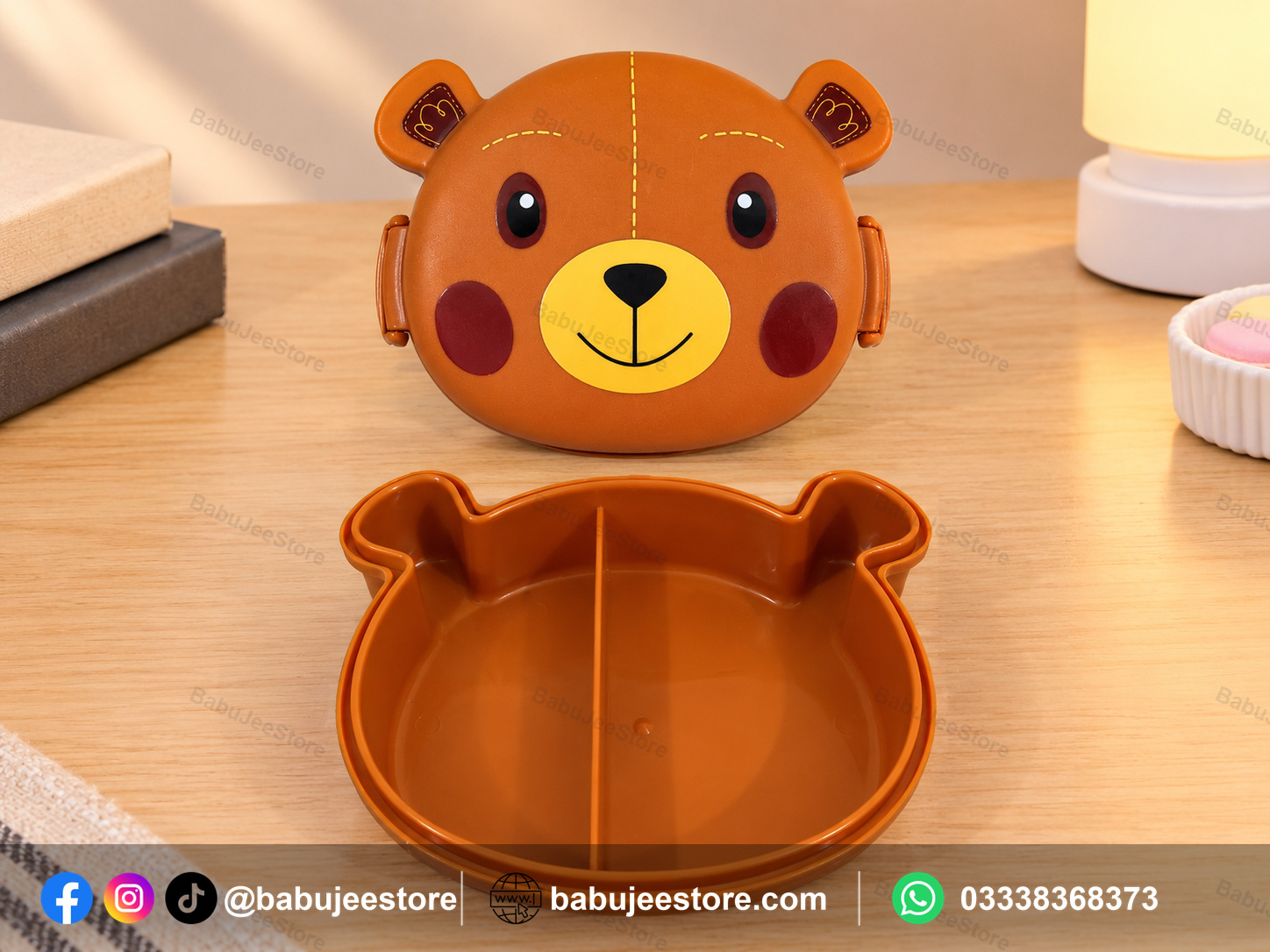 Open orange bear-shaped lunch box showing its divided interior Open orange bear-shaped lunch box showing its divided interior