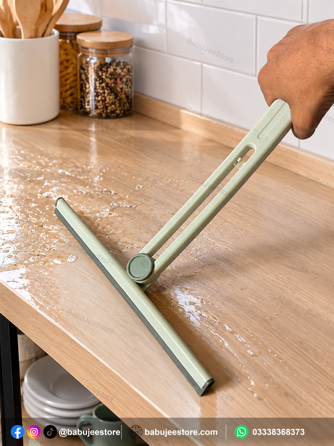 Compact floor squeegee being used on a wet counter surface Compact floor squeegee being used on a wet counter surface